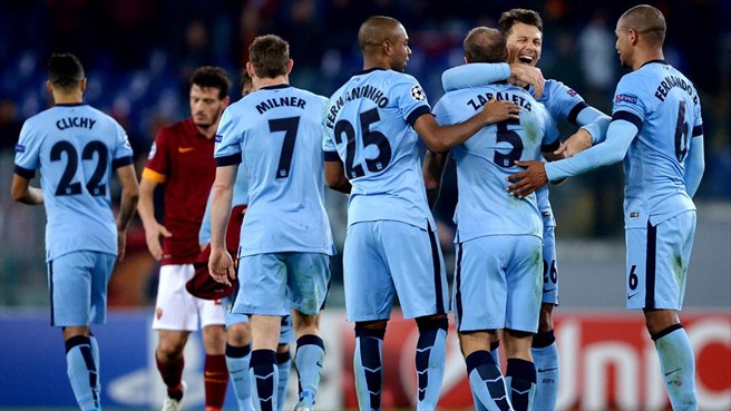 City players celebrate qualifying to the next round after the match against Roma is brought to an end
